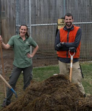 team at the wilds with pile of compost